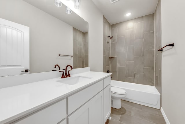 full bathroom featuring toilet, tiled shower / bath, tile patterned flooring, and vanity