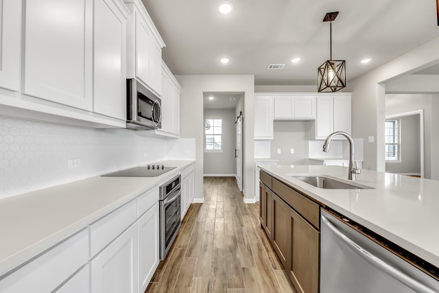 kitchen featuring sink, white cabinetry, and stainless steel appliances