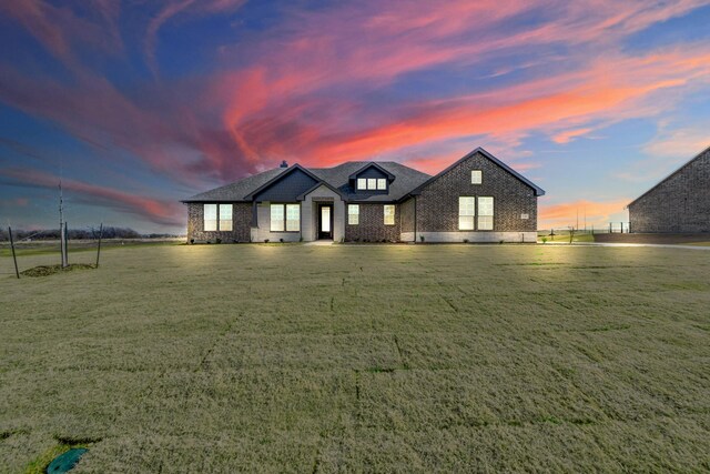 view of front facade featuring a garage, a front yard, and central AC