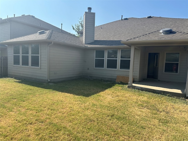 back of house featuring a patio and a yard