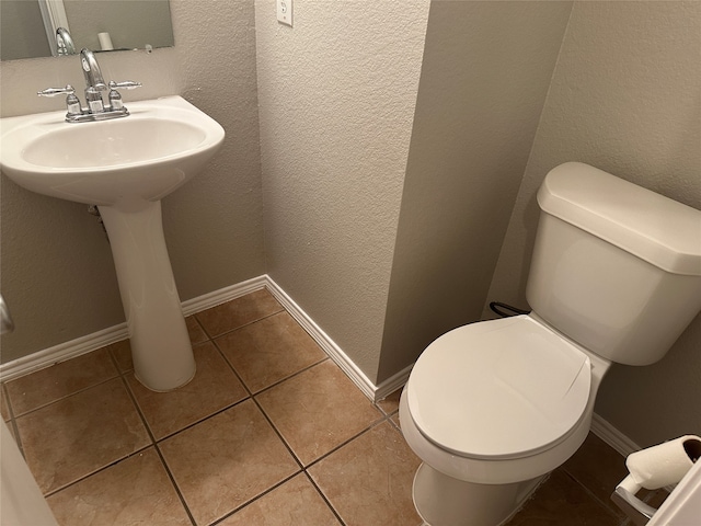 bathroom with toilet and tile patterned floors