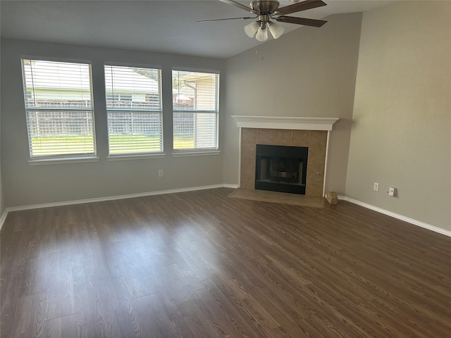 unfurnished living room with ceiling fan, a fireplace, and dark wood-type flooring