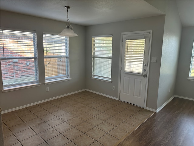 unfurnished dining area with hardwood / wood-style floors and plenty of natural light