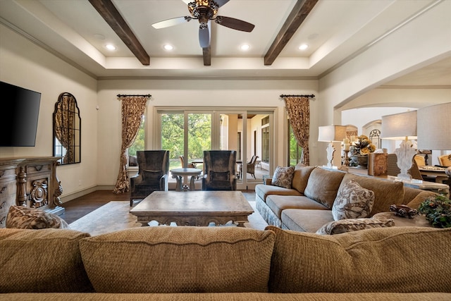 living room featuring beam ceiling, dark hardwood / wood-style floors, and ceiling fan