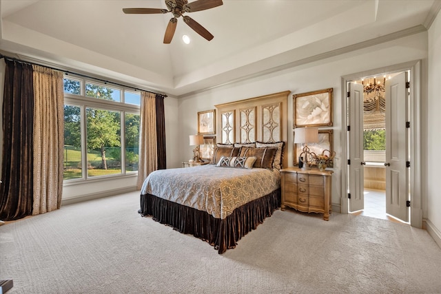 bedroom with multiple windows, ensuite bathroom, ceiling fan, and light colored carpet