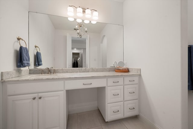 bathroom featuring a notable chandelier, tile patterned floors, and vanity