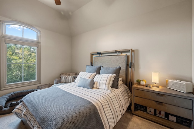 bedroom with vaulted ceiling, ceiling fan, and carpet floors