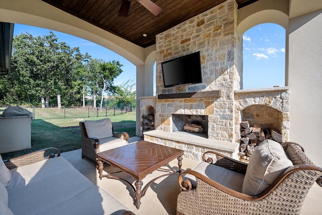 view of patio / terrace with ceiling fan and an outdoor stone fireplace