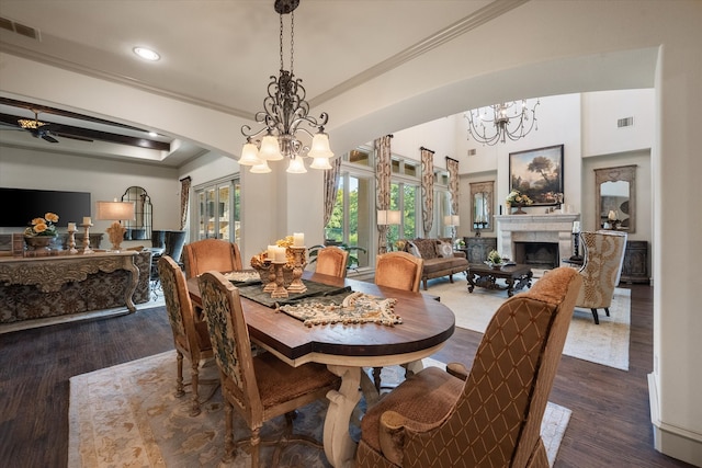 dining room featuring ceiling fan, a fireplace, crown molding, and hardwood / wood-style floors