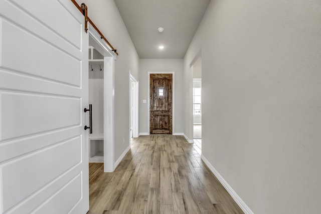 entryway featuring light wood-type flooring and a barn door