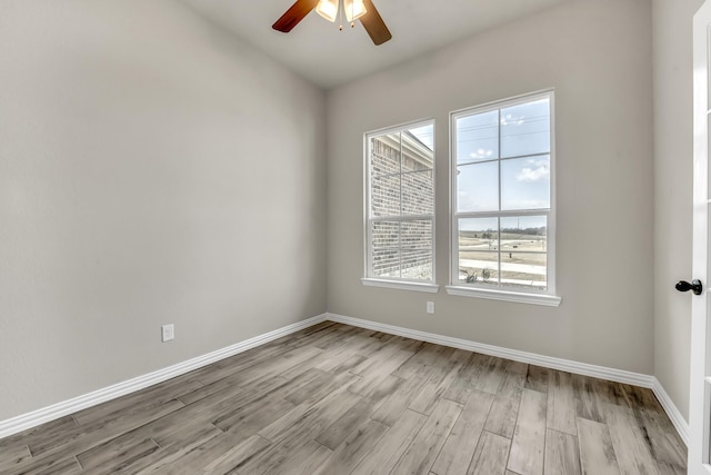 empty room with ceiling fan and light wood-type flooring