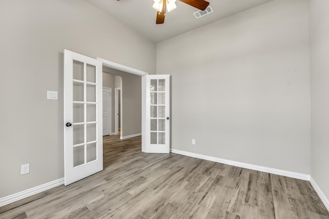 spare room featuring ceiling fan, light hardwood / wood-style flooring, and french doors