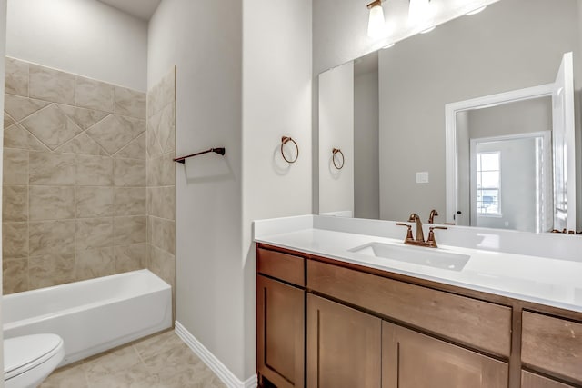 full bathroom featuring toilet, vanity, tiled shower / bath combo, and tile patterned floors