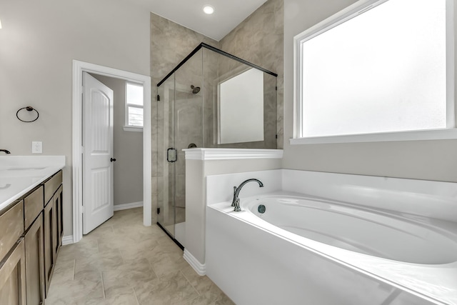 bathroom featuring vanity and separate shower and tub