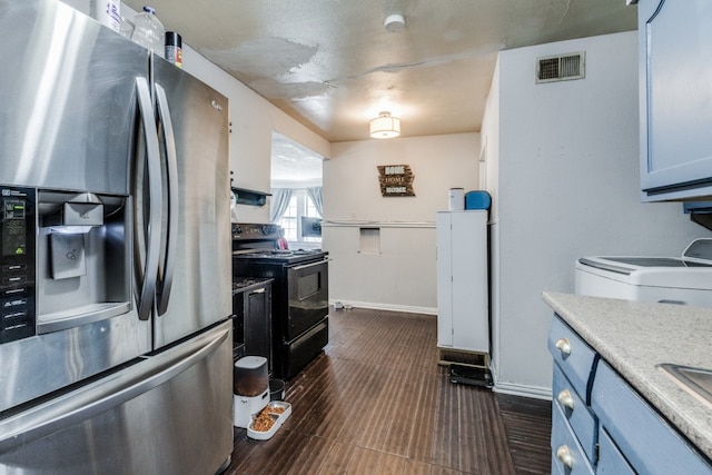 kitchen featuring stainless steel fridge, dark wood-type flooring, white cabinetry, black / electric stove, and washer / clothes dryer