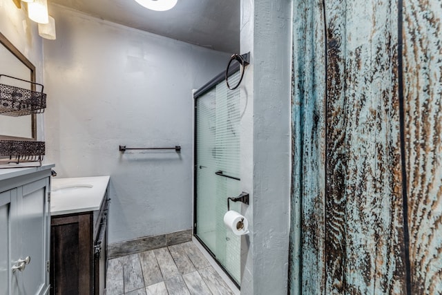 bathroom featuring vanity, an enclosed shower, and hardwood / wood-style flooring