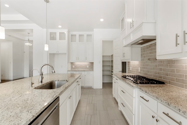 kitchen with pendant lighting, appliances with stainless steel finishes, and white cabinets