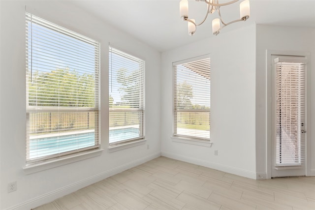 unfurnished dining area with a notable chandelier