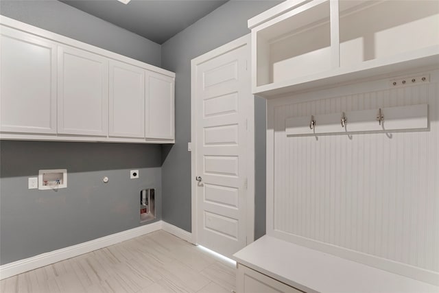 laundry area with hookup for a washing machine, cabinets, gas dryer hookup, and electric dryer hookup