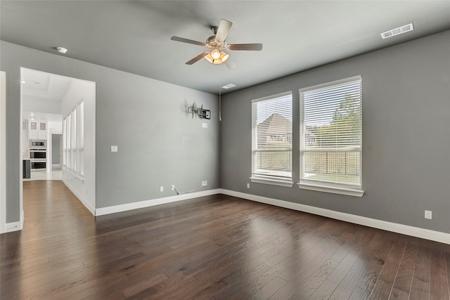 unfurnished room featuring dark hardwood / wood-style flooring and ceiling fan