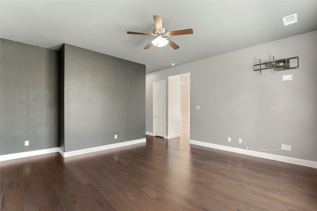 empty room featuring dark wood-type flooring and ceiling fan