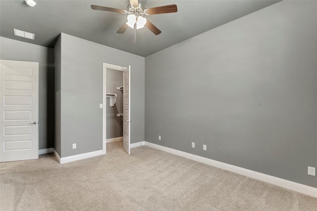 unfurnished bedroom featuring ceiling fan and light colored carpet