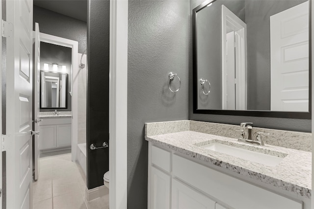 bathroom with tile patterned flooring, vanity, and toilet