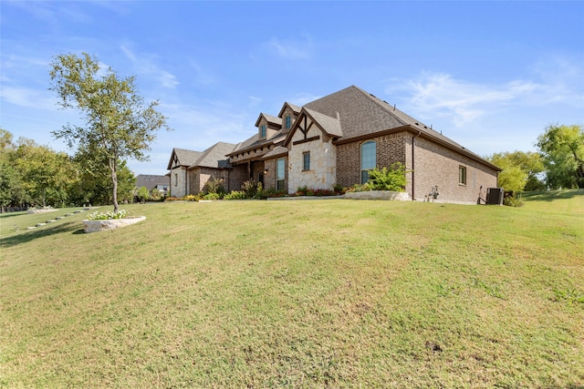 view of home's exterior featuring central AC unit and a yard