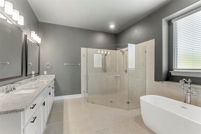 bathroom featuring tile patterned floors, vanity, a wealth of natural light, and independent shower and bath