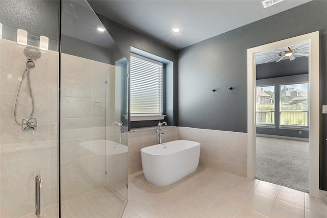 bathroom with ceiling fan, separate shower and tub, and tile patterned flooring