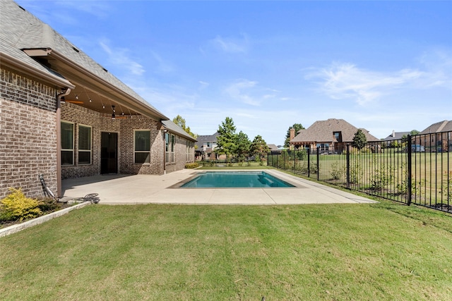 view of swimming pool featuring a yard and a patio