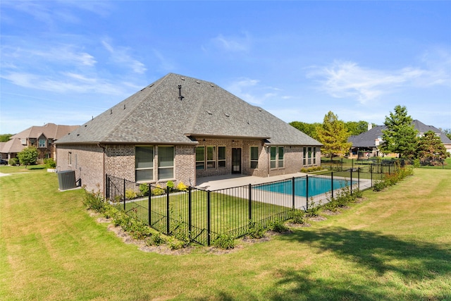 view of pool with central air condition unit, a patio, and a yard