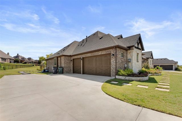 view of side of property featuring a lawn and a garage