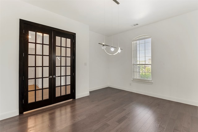 spare room with french doors and dark hardwood / wood-style floors