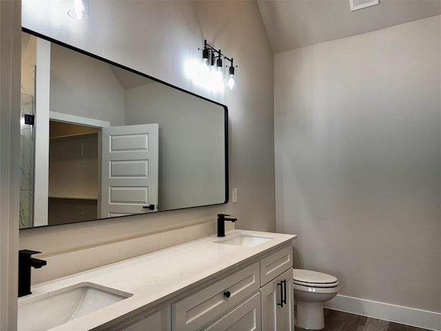 kitchen featuring white cabinetry, a kitchen island, pendant lighting, stainless steel appliances, and light hardwood / wood-style flooring