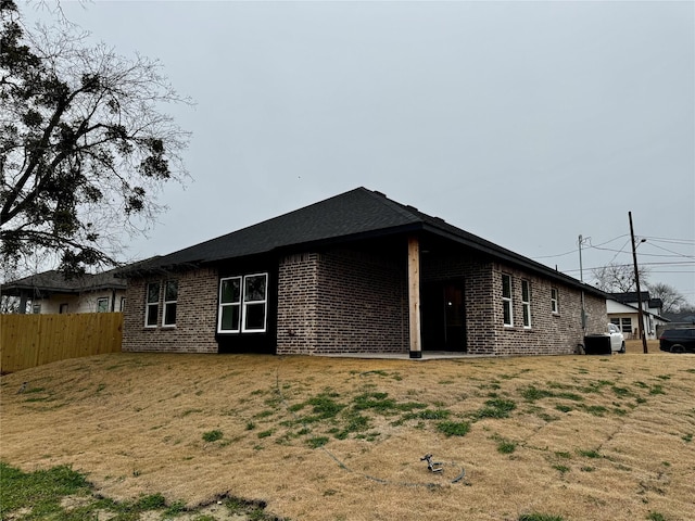 view of side of property with a lawn