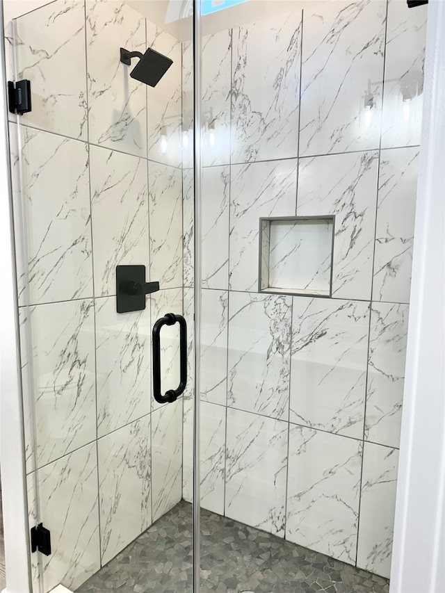 bathroom with a shower with shower door