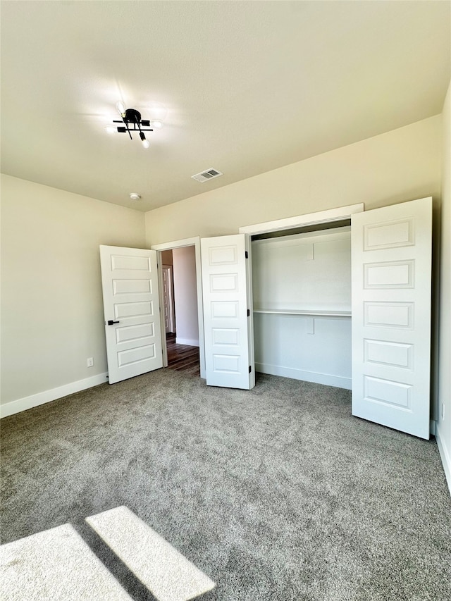 unfurnished bedroom with carpet and a closet