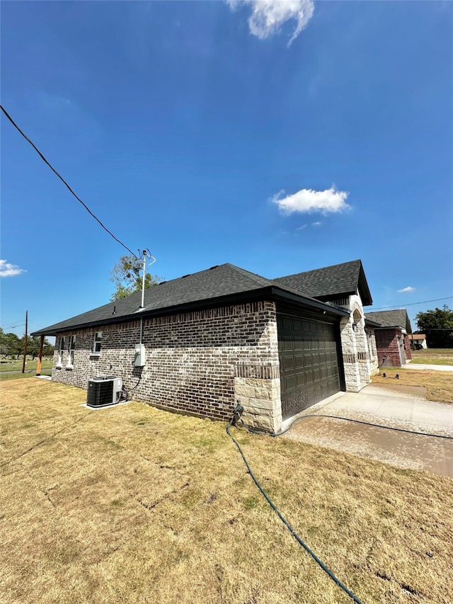 view of property exterior with cooling unit, a yard, and a garage