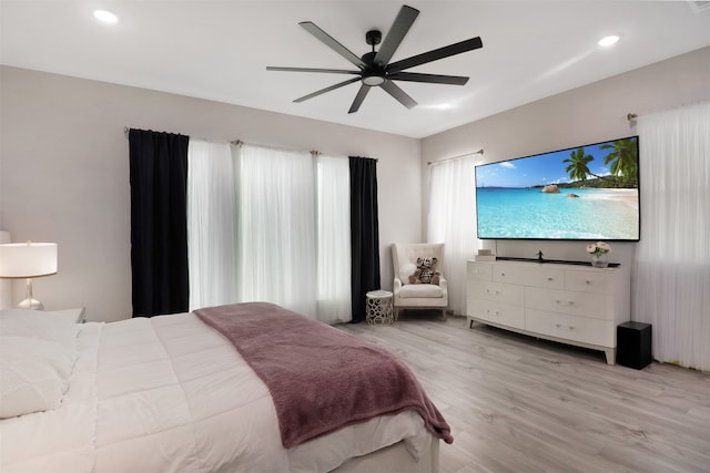 bedroom with light hardwood / wood-style floors and ceiling fan