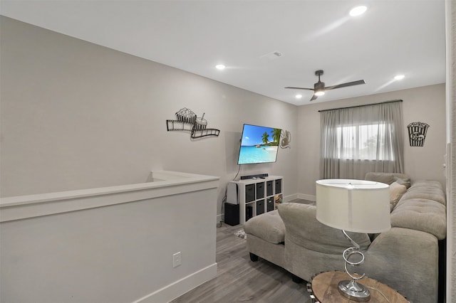 living room featuring ceiling fan and hardwood / wood-style flooring