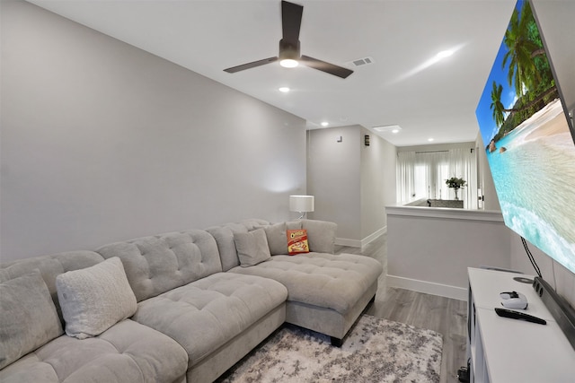 living room with ceiling fan and light hardwood / wood-style flooring