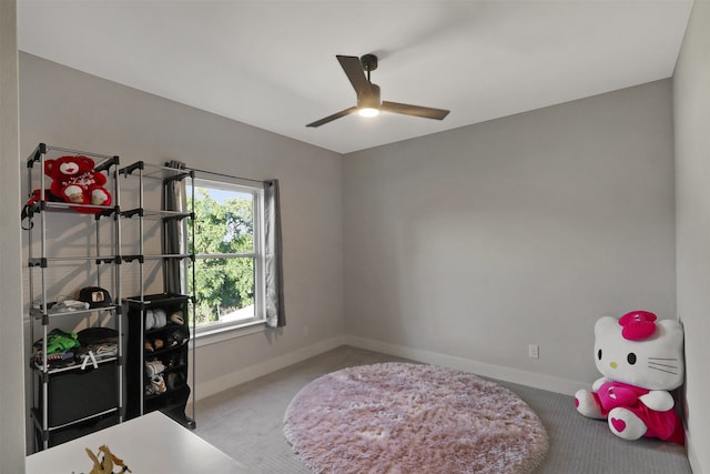 recreation room featuring light carpet and ceiling fan