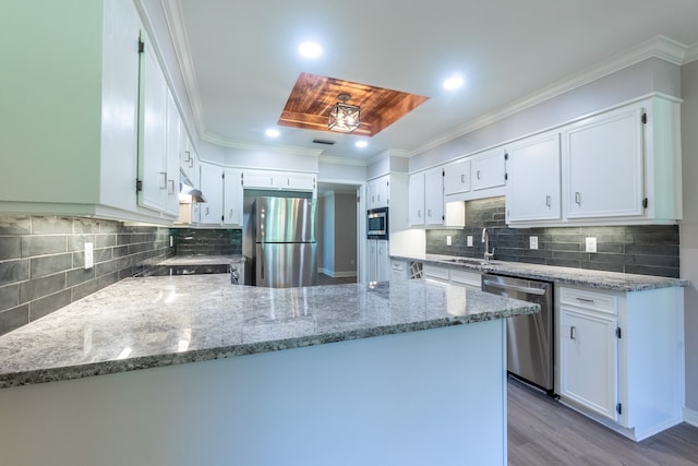 kitchen with crown molding, light hardwood / wood-style flooring, appliances with stainless steel finishes, light stone countertops, and white cabinets