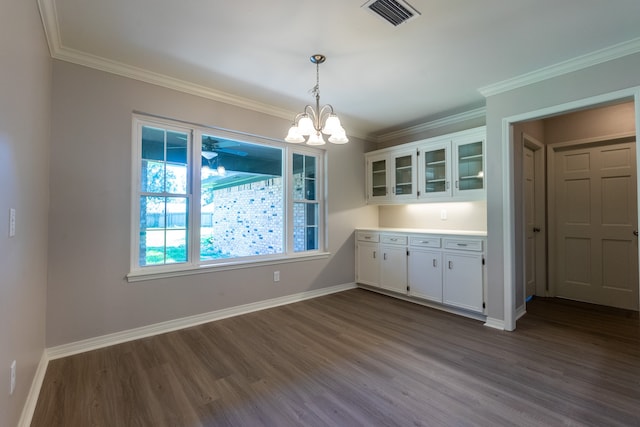 unfurnished dining area with crown molding, hardwood / wood-style floors, and a notable chandelier