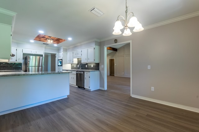 kitchen with stainless steel appliances, white cabinetry, hanging light fixtures, and dark wood-type flooring