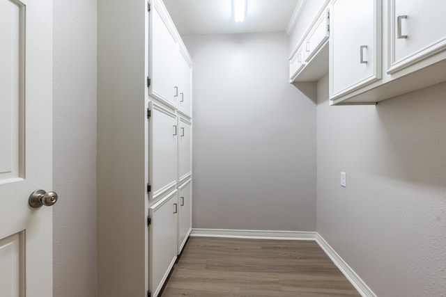 clothes washing area with wood-type flooring