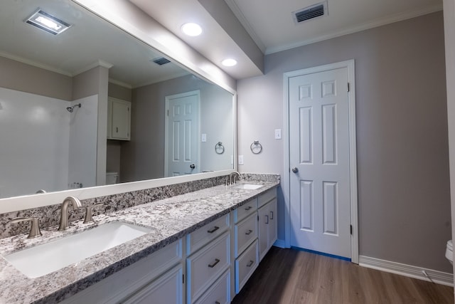 bathroom with hardwood / wood-style flooring, ornamental molding, toilet, and vanity