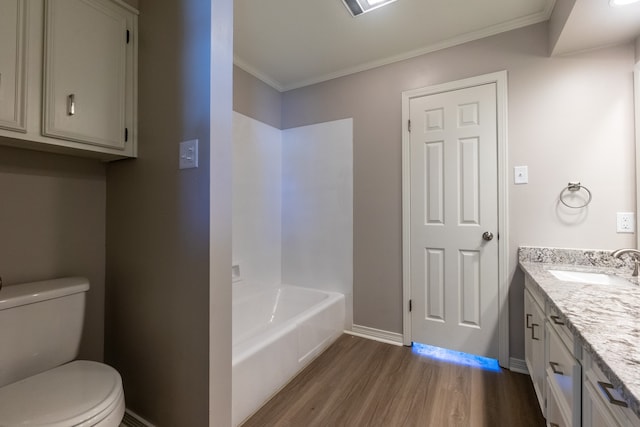 bathroom featuring toilet, crown molding, wood-type flooring, vanity, and a bathing tub