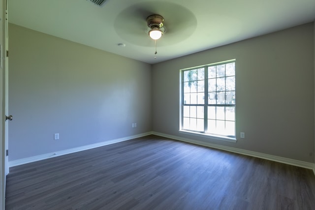 empty room featuring ceiling fan and dark hardwood / wood-style flooring